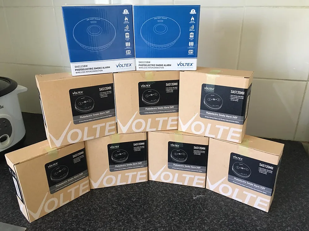 Boxes of VOLTE photoelectric smoke alarms ready to install