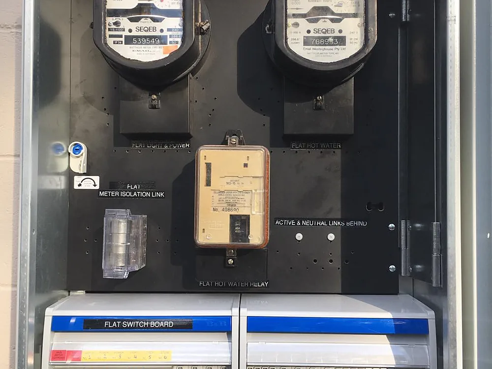 Upgraded switchboard in a meter box with new circuit breakers and safety switches