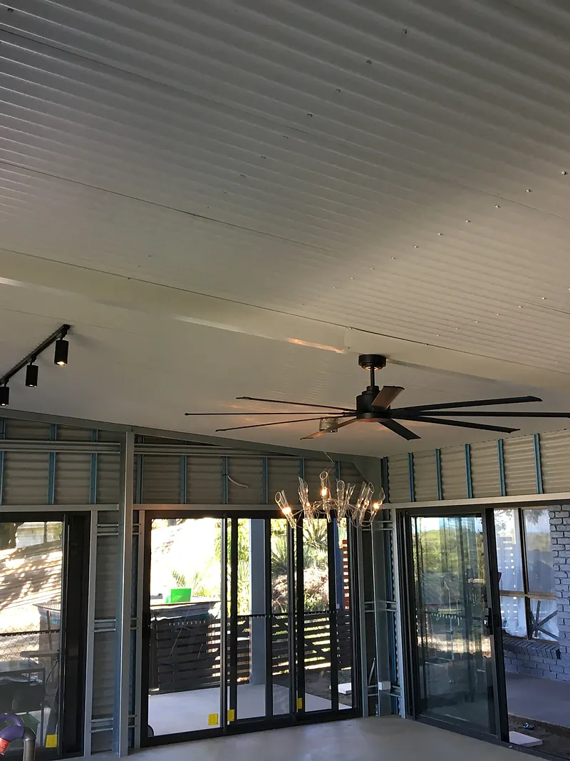 Extension with a large ceiling fan and track lighting