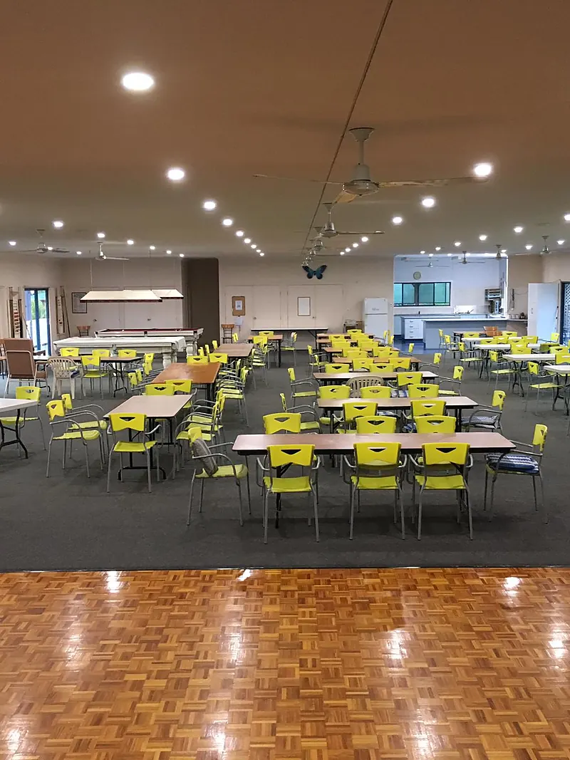 Community hall with rows of LED downlights over tables