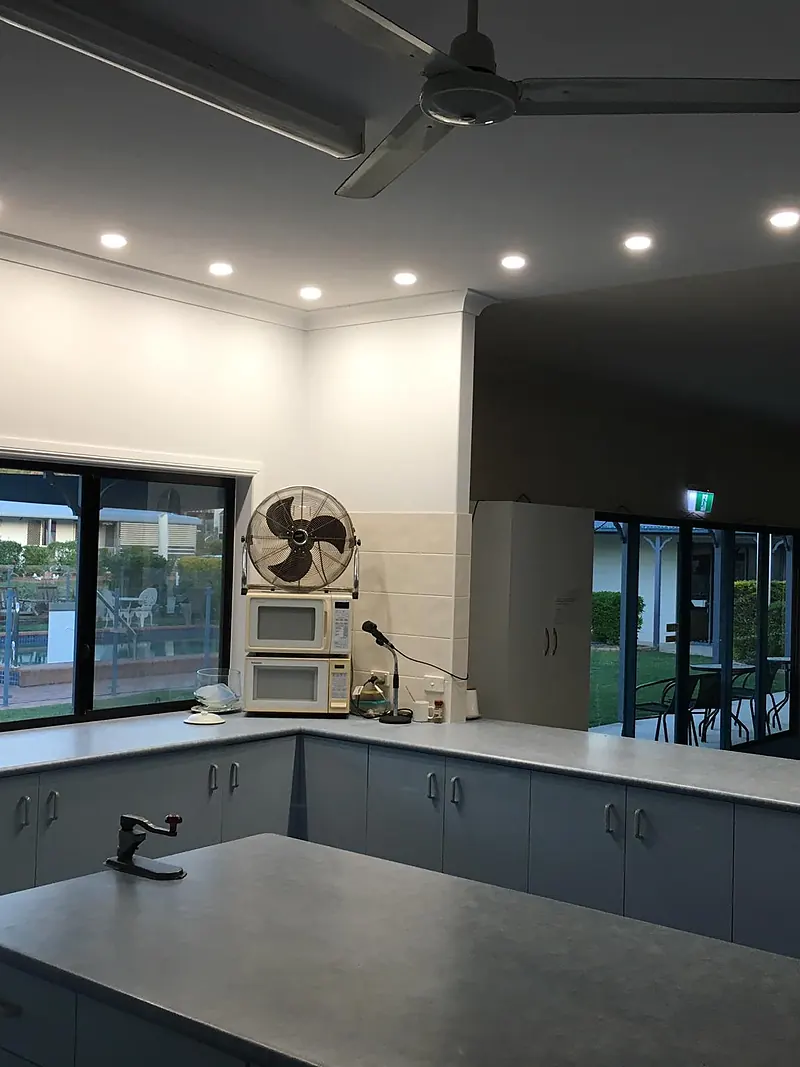 Commercial kitchen with LED downlights and a ceiling fan