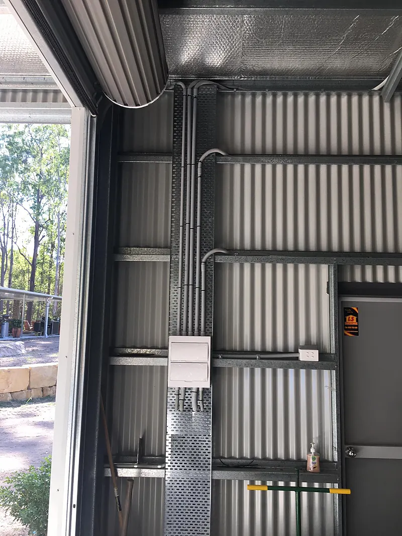 Shed wall with conduit runs and switchgear